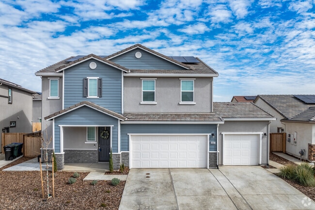 This Modern Craftsman-style home has a 3-car garage and 2 stories in Vineyard.