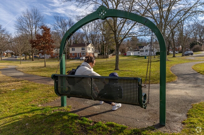 Sudbrook Park offers an adult park swing, comfortable benches, and numerous walking trails.