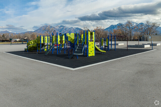 Midvalley Elementary School’s large playground’s bright colors stand out agains the mountains.