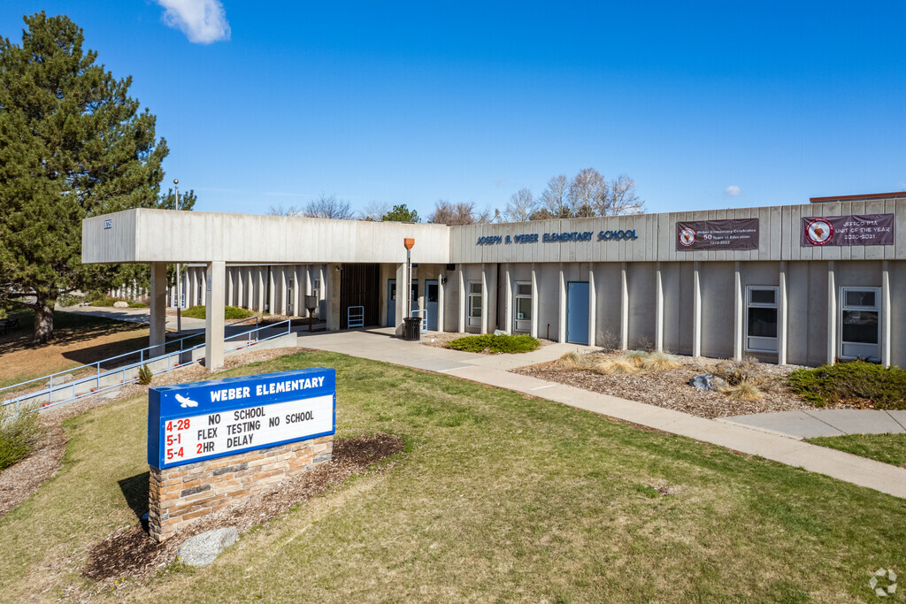 Meadowglen Weber Elementary School sign and entrance on a blue sky day.