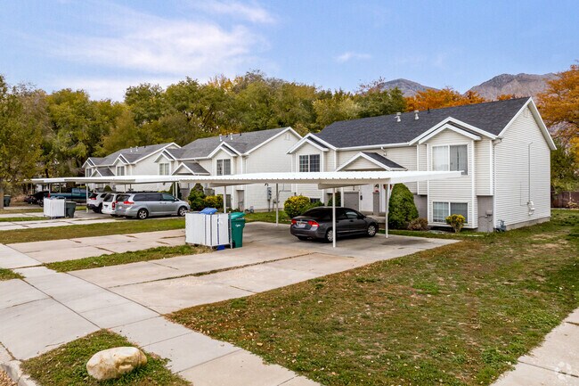 Charming townhomes with white siding line this neighborhood street in Lynn.