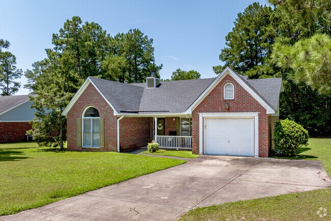 Brick ranch homes with a garage have well maintained landscaping in Rockfish.