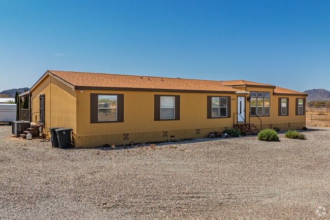 An elongated manufactured home showcases Aguila's spacious lots, ideal for comfortable desert living.