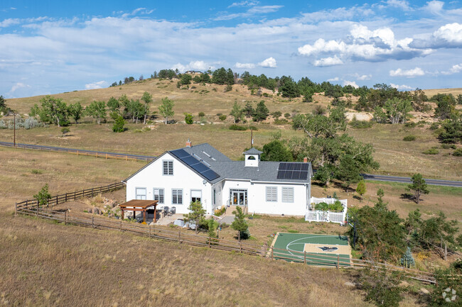 Nestled in a tranquil field, this Eldorado Springs home offers peace and countryside views.