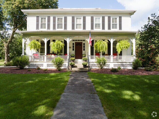 A colonial with a perfect porch and hanging garden to create shade and enjoy in Hatfield, MA.
