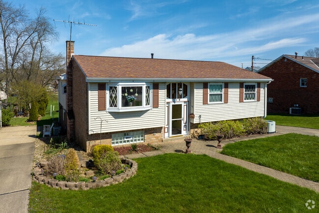 A single level paneled home with wrap-around driveway in the Liberty community.