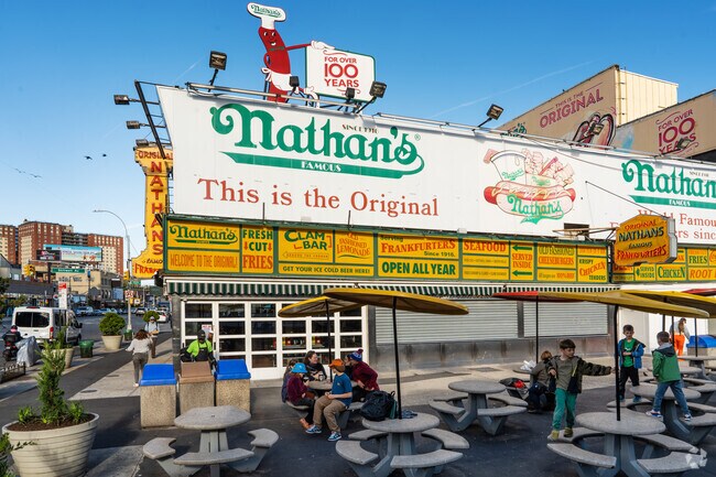 Enjoy a classic Nathan's Hot Dog at Coney Island's lively boardwalk.