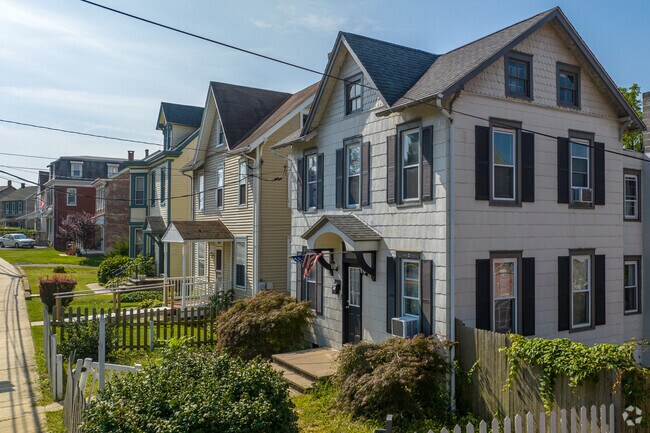 Colonial revivals in Saint Lawrence have but colorful shutters and symmetrical shapes.