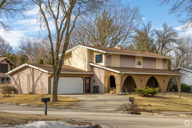 This midcentury modern home features stone arches at it's entrance.