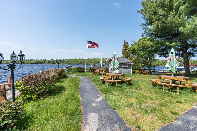 Harrison residents enjoy lakeside lunch behind the Village Tie Up right on Long Lake’s shores.