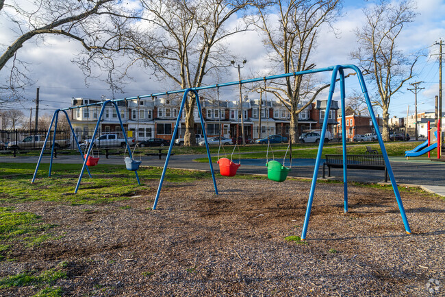 Push the kids on the swing set at William Judy Johnson Memorial Park.