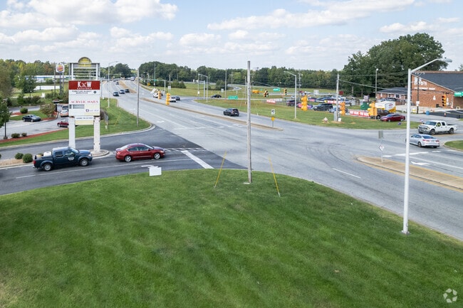 A roadway with shops and businesses near Polecat Creek.