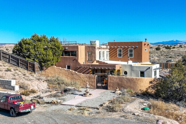 Santa Fe style homes feature flat roofs and stucco covered exteriors in Arroyo Seco..