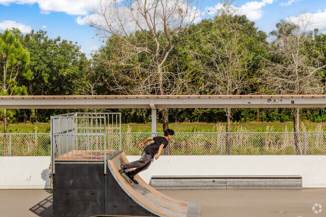 A kid enjoys some skatepark fun ramping on his board in West Boynton park.