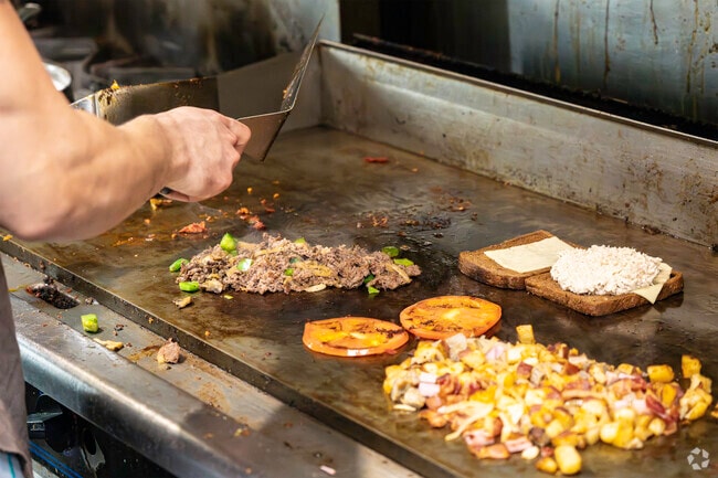 The chef at Emma Lisa’s Breakfast & Lunch prepares fresh dishes for customers.