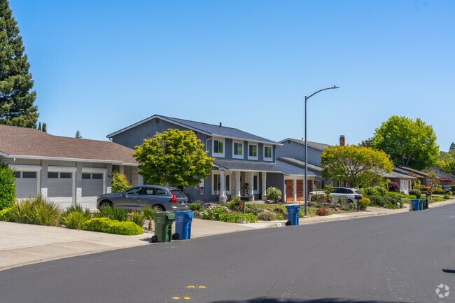 A row of homes in Greenbrook sit along a quiet tree lined street.