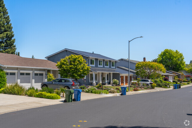 A row of homes in Greenbrook sit along a quiet tree lined street.