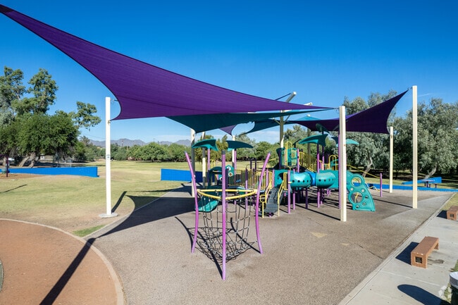A shaded playground for children at Limberlost Family Park.
