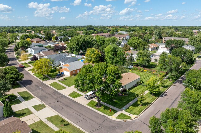 The neighborhood of Brunsdale surrounded by lush green trees and beautiful lawns.