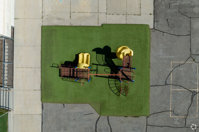 A colorful playground sits atop green turf at Roosevelt Continuation School.