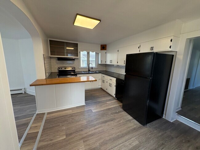 Kitchen with island and room for kitchen table