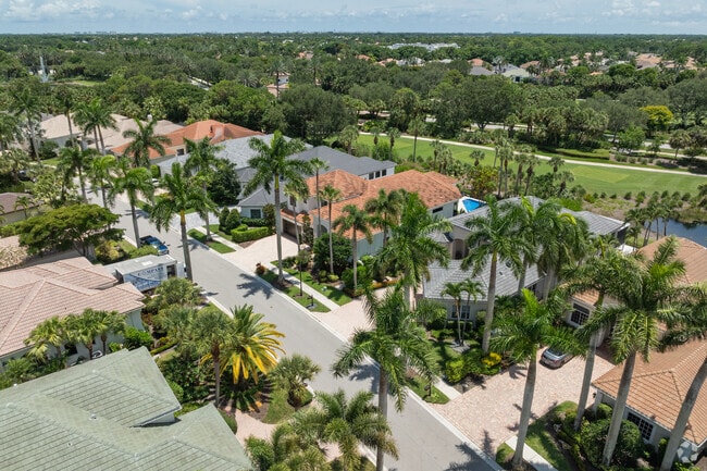 Homes in Addison Reserve sit among pine trees and a private golf course.