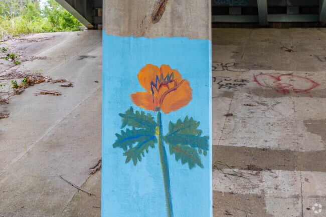Artists have painted columns under the highway near Dolly McNutt Court for culture.
