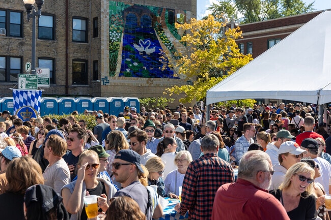 Large crowds flood the streets of Lincoln Square during Oktober Fest.