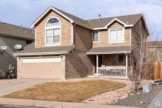 A craftsman-style home in Montbello features a two-car garage and a covered porch.