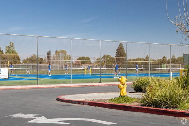 Students practicing tennis on the campus of Rio Americano High School.