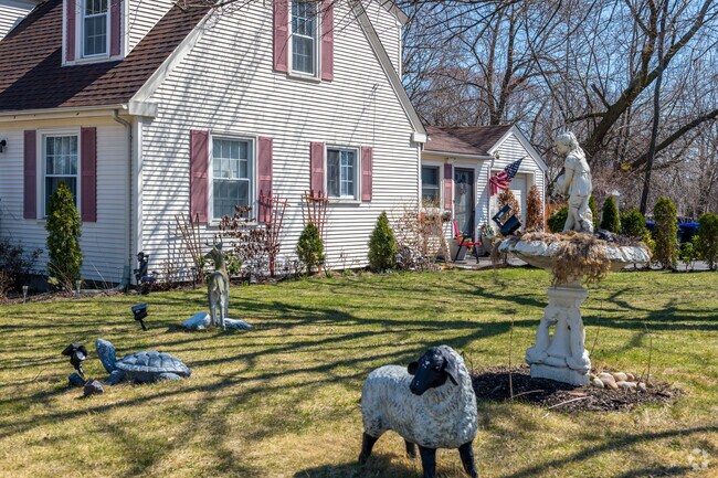 This Arlington home features eclectic lawn decorations and a cozy front yard.