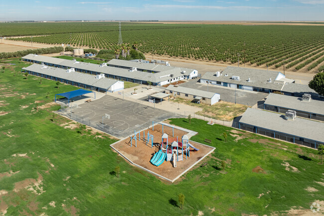 Westside Elementary School provides a large green area and play equipment for students.