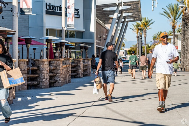 Shoppers flock to The Outlets at Orange for deals and entertainment.