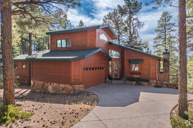 Forest Highlands features earth-toned wood siding homes with floor to ceiling windows.