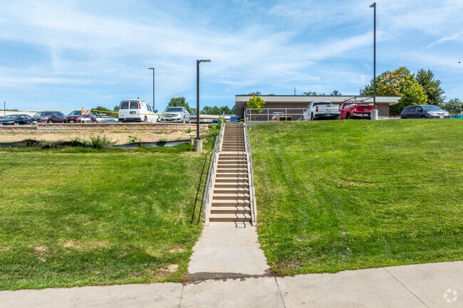 A stairway connects the sidewalk to the main entrance of Horn Elementary.