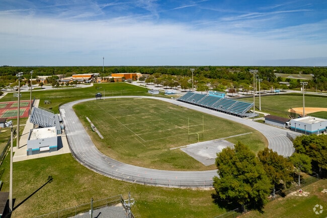 Students shine in front of their parents playing football on the field at West Port High School.