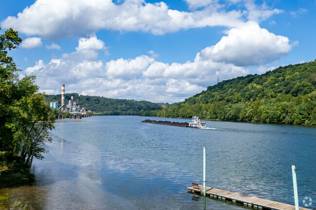 Large barges go up and down the Monongahela River past New Eagle.