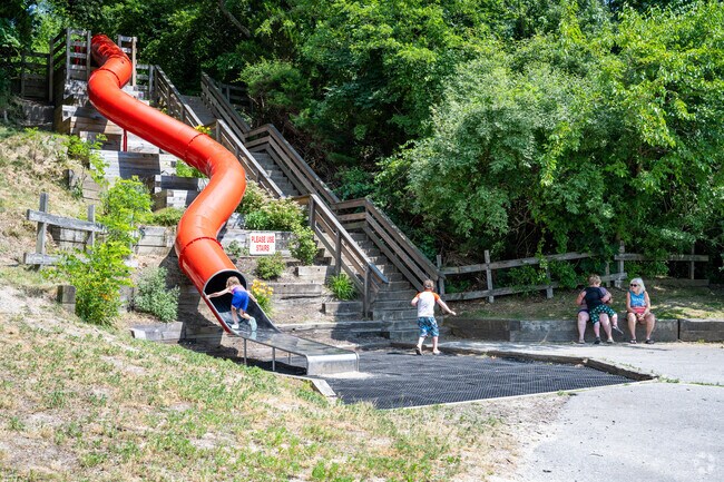Discover joy as kids slide down the Big Red Slide in Somerset Historic Village, MA.
