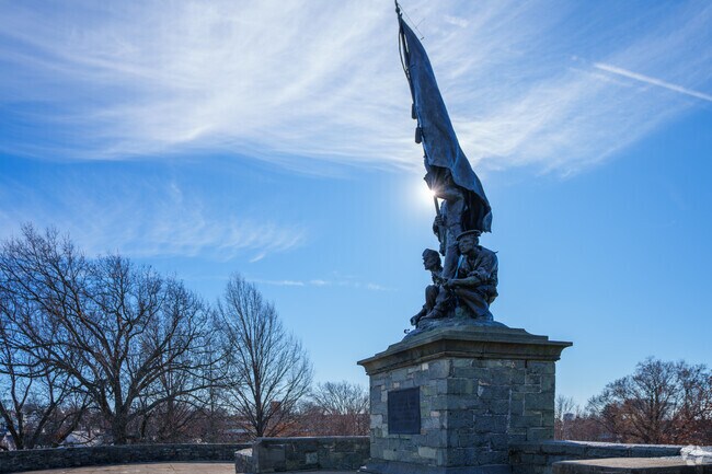 Visitors stop and wonder at the Soldiers' Monument in Bell Rock Memorial Park, Belmont.