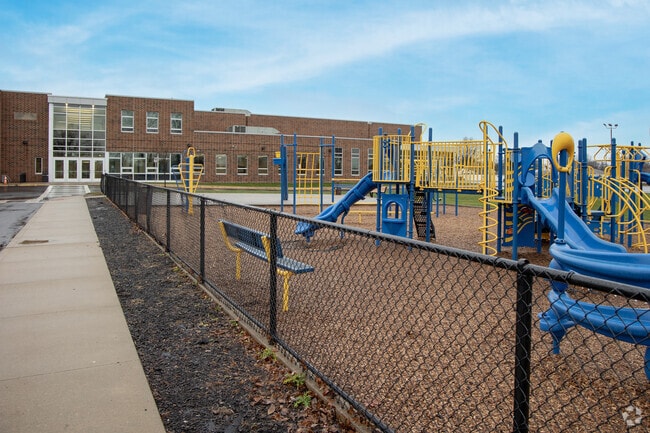 Brooklyn Elementary School housed a colorful playground with a slide and swing set.