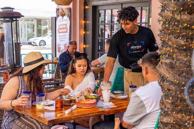 People enjoying a meal outside along Espanola Way in Flamingo.