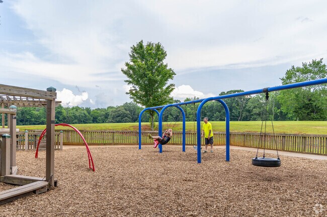 Fathers can swing with their kids at the playground at Sharon Johnston Park in New Market.