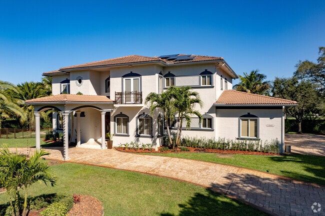 Modern two-story Spanish style homes are spread throughout the Flamingo Groves, FL neighborhood.