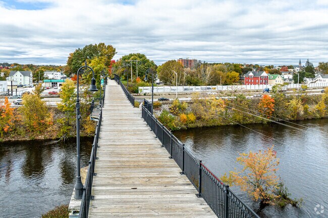 The wide, wooden plank bridge takes you up and over I-293 and then the river.