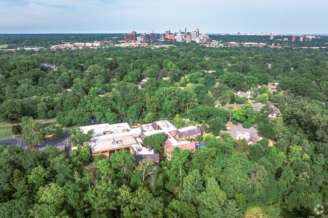 Community School is surrounded by greenery and tress.