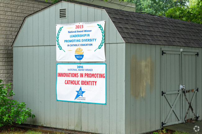 Signage of St. Francis International School highlights awards and accolades.