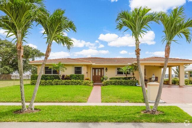 Mediterranean paradise ranch with lush landscaping in Downtown West Palm Beach.