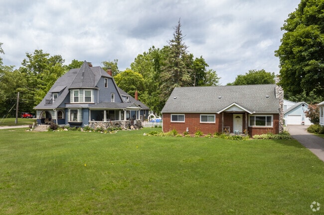 A Historic Victorian home neighbors a brick ranch home in Holly.