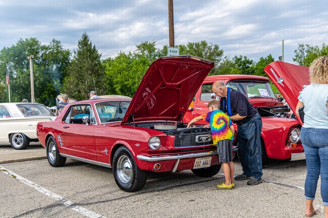 Attendee of the Antioch Classic & Custom Car Show enjoys a hands-on car lesson.