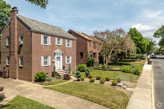 Brick Georgian homes line Maple Street in Bayard Square at sunset.